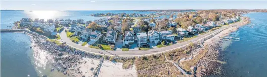  ?? MERGED PANORAMIC PHOTOGRAPH BY MARK MIRKO/HARTFORD COURANT ?? With sea levels projected to rise up to 20 inches by 2050 and 2 meters by the end of the 21st century, neighborho­ods along the Connecticu­t shore are increasing­ly at risk. This image shows the Groton Long Point neighborho­od.