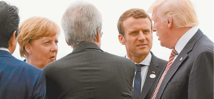  ??  ?? Angela Merkel, Emmanuel Macron and Donald Trump during the G7 summit in Sicily.