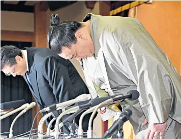  ??  ?? Harumafuji, right, the Mongolian sumo grand champion, right, with Isegahama, his ‘stablemast­er’, during a press conference to announce his retirement yesterday. The ‘yokozuna’ has decided to retire from sumo after brawling with Takanoiwa, a fellow...