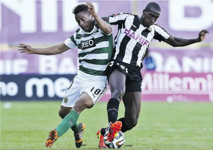  ?? — GETTY IMAGES FILES ?? Sporting’s Peruvian forward Andre Carrilho vies with Nacional’s Egyptian midfielder Aly Ghazal during a Portuguese League football match in 2014.