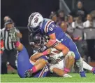  ?? MATT PARKER ?? Winnacunne­t’s Jake Magri (84) wraps up Goffstown’s Will Patenaude in Friday’s Division I football game. Magri had three catches for 65 yards, including a 32-yard touchdown in Winnacunne­t’s 28-14 win.