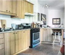  ??  ?? The kitchen in Cohen’s airy condo, which has 1,300 square feet of living space. He had several walls removed when he moved in.