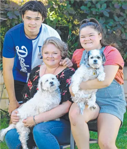  ??  ?? SWITCHED: Simmone Le Raye, 39, and children Declan, 16, and Mikenzie, 13, with dogs Cooper and Chloe. Picture: Tom Huntley