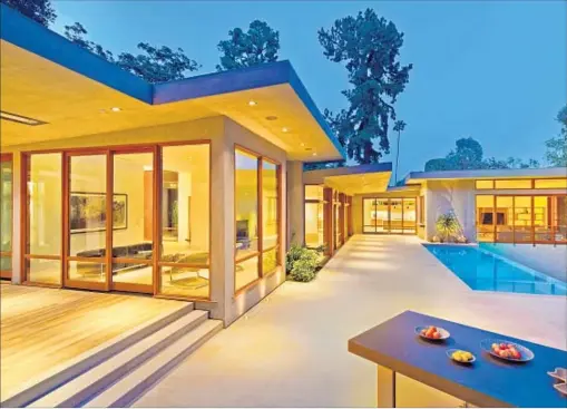  ?? Photograph­s by Bill Singleton ?? A RENOVATION and expansion have given the midcentury Beverly Crest home modern comforts. The asking price is $16.9 million.