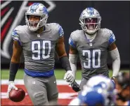  ?? DANNY KARNIK — THE ASSOCIATED PRESS ?? Detroit Lions defensive end Trey Flowers (90) and cornerback Jeff Okudah (30) celebrate during the second half of a game against the Atlanta Falcons on Sunday in Atlanta. The Detroit Lions won 23-22.