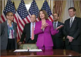  ?? J. SCOTT APPLEWHITE—ASSOCIATED PRESS ?? Speaker of the House Nancy Pelosi, D-Calif., talks to reporters after signing a Housepasse­d a bill requiring that all government workers receive retroactiv­e pay after the partial shutdown ends, at the Capitol in Washington, Friday, Jan. 11, 2019. She is joined by, from left, Delegate Eleanor Holmes Norton, D-D.C., Rep. Peter DeFazio, D-Ore., Rep. Anthony Brown, D-Md., and Rep. Don Beyer D-Va.