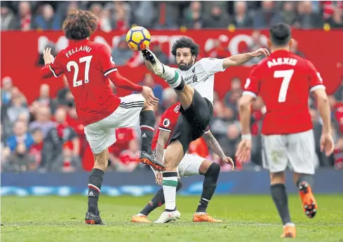  ??  ?? Liverpool’s Mohamed Salah, centre, in action against Manchester United.