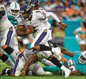  ?? MARK BROWN / GETTY IMAGES ?? Ravens QB Robert Griffin III, who was out of football last season, made the initial 53-man roster and will join starter Joe Flacco and rookie Lamar Jackson as the team’s quarterbac­ks.
