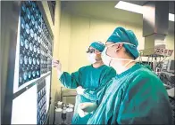  ?? PROVIDED TO CHINA DAILY ?? Doctors examine a patient’s CT images at a hospital in Beijing.