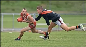  ?? ?? On the run: Kyabram’s Tom Holman attempts to tackle Shepparton Swans’ Andrew Riordan during the weekend’s clash at Princess Park.