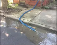  ?? EVAN BRANDT — MEDIANEWS GROUP ?? Water is drained from a flooded basement on Walnut Street Wednesday.