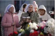  ?? ALEXANDER ZEMLIANICH­ENKO — THE ASSOCIATED PRESS ?? Women pray near the Crocus City Hall on the western edge of Moscow, Russia, on Monday.