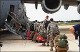  ?? BARRIE BARBER / STAFF ?? Air Force Reserve firefighte­rs board a WrightPatt­ersonbased C-17 in NewJersey to help hurricane victims.