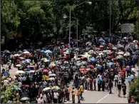  ?? AP/MATT DUNHAM ?? People line up Wednesday to get on buses to be taken to the government offices building in Pretoria where the body of former South African President Nelson Mandela is lying in state.