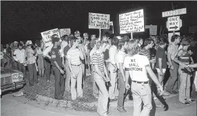  ??  ?? Gay rights marchers rallied against singer Anita Bryant, an outspoken anti-gay figure. Bryant was to perform at the State Bar of Texas dinner at the Hyatt Regency.