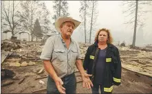  ?? DAVID MCNEW / AFP ?? Rancher Gary Rainey and volunteer fire department chief Janet Jones on Monday stand amid the ruins of the community hall in Klamath River, California.