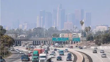  ?? Frederic J. Brown/ AFP/Getty Images file photo ?? A layer of smog covers downtown Los Angeles in 2018. The EPA decision means that one of the agency’s most important air quality regulation­s will not be updated until well after the 2024 presidenti­al election.