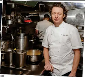  ?? ?? MENU FOR CHANGE: Tom Kitchin, left with his wife Michaela, is striving to improve working conditions for staff at his upmarket restaurant­s
