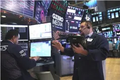  ?? — AFP photo ?? Traders work on the floor of the New York Stock Exchange in New York City.