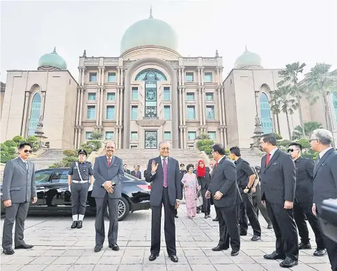  ??  ?? Dr Mahathir, accompanie­d by Chief Secretary Tan Sri Dr Ali Hamsa (second left), after addressing the Prime Minister’s Department at Dataran Putra. — Bernama photo