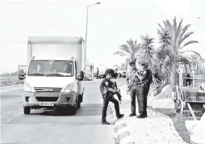  ?? — Gambar AFP ?? ANGGOTA polis rejim berkumpul di lokasi serangan di Taman Perindustr­ian Barkan berdekatan penempatan haram Ariel di wilayah terjajah Tebing Barat,
semalam.