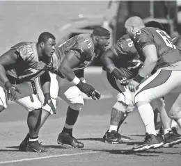  ?? ROB SCHUMACHER/AZCENTRAL SPORTS ?? Cardinals offensive linemen D.J. Humphries (74) and Earl Watford (78) work during a recent practice at the team’s training facility in Tempe.