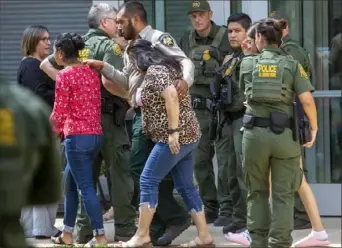  ?? William Luther/The San Antonio Express-News via AP ?? People leave the Uvalde Civic Center on Tuesday after a shooting earlier in the day at Robb Elementary School in Uvalde, Texas.