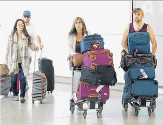  ??  ?? Family fortunes: Meghan’s nephews, Tyler and Thomas Dooley, with their mother Tracy Dooley Markle (above centre) arrive at Heathrow. Below, baby Meghan is held by her half-brother, Tom Markle, in Los Angeles in 1982