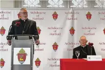  ?? John Moritz/Hearst Connecticu­t Media ?? The Rev. Christophe­r Coyne, left, speaks Monday upon being named coadjutor bishop for the Archdioces­e of Hartford. Currently serving as the bishop in Burlington, Vt., Coyne will succeed Connecticu­t’s Archbishop Leonard Blair upon the latter’s retirement next year.