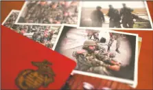  ?? (AP/Jessie Wardarski) ?? A group of old photos laying on Shams’ desk in his Baltimore home Aug. 13 show him as a young Marine.