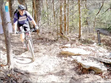  ?? Keith Bryant/The Weekly Vista ?? Todd Thibodeau, a rider from Wyoming who came to Northwest Arkansas for the Internatio­nal Mountain Bicycling Associatio­n’s world summit, rides out of the Back 40 trail and toward the Blowing Springs pavilion. The trails were finished just in time for...