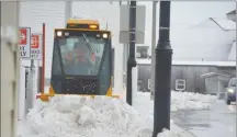  ?? COLIN MACLEAN/JOURNAL PIONEER ?? City of Summerside staffers cleared the sidewalks Thursday after a winter storm hit the city causing a power outage across the area and the Island.