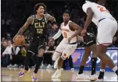  ?? JOHN MINCHILLO — THE ASSOCIATED PRESS ?? Charlotte Hornets guard Kelly Oubre Jr. (12) drives around New York Knicks guard RJ Barrett (9) during the first half Tuesday.
