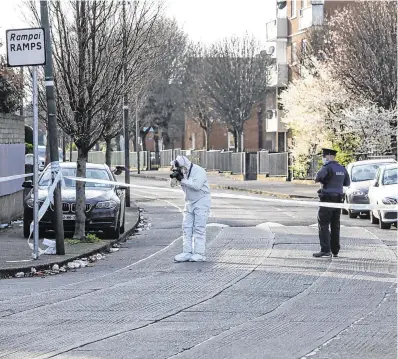  ?? PHOTO: FERGAL PHILLIPS ?? Search: Garda technical officers near the scene of the shooting at Bernard Curtis House in Dublin’s south inner city on Saturday.