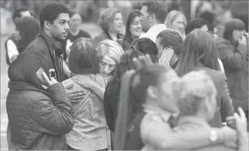  ?? Ben Stansall AFP/Getty Images ?? RETAIL WORKERS wait after they were evacuated from a mall in Manchester because of a security alert. Prime Minister Theresa May said military personnel will be deployed at key locations around the country.