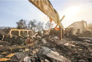  ?? RINGO H.W. CHIU/THE ASSOCIATED PRESS ?? A burned home near Iron Canyon Road in Santa Clarita, Calif. A raging wildfire that forced thousands from their homes on the edge of Los Angeles continued to burn Tuesday as frustrated fire officials said residents reluctant to heed evacuation orders...