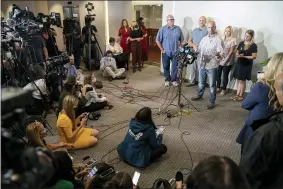  ?? AP PHOTO/JOHN MINCHILLO ?? Jim Schmidt, stepfather of Gabby Petito, whose death on a cross-country trip has sparked a manhunt for her boyfriend Brian Laundrie, speaks alongside Joseph Petito, father, immediate left, Tara Petito, stepmother, second from right, and Nichole Schmidt, mother, right, during a news conference, Tuesday, Sept. 28, 2021, in Bohemia, N.Y.