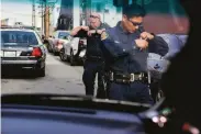  ?? Santiago Mejia / The Chronicle 2019 ?? Sgt. Davin Cole (left) and Officer Robert Rueca respond to a San Francisco car break-in in 2019.