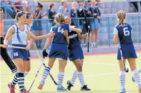  ??  ?? COMPOSED FINISH: Taz Preller (No 4) congratula­tes Collegiate teammate Monique Titus after their first goal against Rhenish in their school hockey match at Collegiate on Saturday