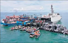  ??  ?? Fishermen arrive on their boats to receive doses of Sinovac’s Covid-19 vaccine on board an Indonesian navy ship off the coast of Riau.