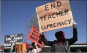  ?? PHOTO BY ANNE WERNIKOFF — CALMATTERS ?? A group of anonymous demonstrat­ors calling themselves Guerrilla Momz protest against school closures during a rally to open schools for in-person instructio­n at Astro Park in Oakland on Feb. 28.