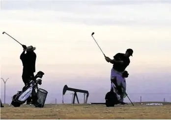  ?? James Durbin / Midland Reporter-telegram ?? The oil and gas industry’s impact on Midland is ubiquitous, even on this driving range.