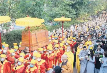  ?? THANH VO/AP ?? Funeral farewell: The coffin of Vietnamese Buddhist monk Thich Nhat Hanh is carried to the street Saturday during his funeral in Hue, Vietnam. The service was held a week after the renowned Zen master died at the age of 95. Nhat Hanh was globally recognized for spreading the practice of mindfulnes­s and socially engaged Buddhism.