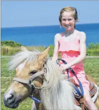  ?? CHRISTIAN ROACH/CAPE BRETON POST ?? Colby Lynk rides the pony Goldie at the Cape Breton Miners’ Museum on Tuesday. This is the first week the ponies are available to ride. The museum is trying to find other attraction­s that can be enjoyed above ground.