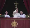  ?? GREGORIO BORGIA/THE ASSOCIATED PRESS ?? Pope Francis waves to faithful at the end of the Urbi et Orbi (Latin for ‘to the city and to the world’ ) Christmas’ day blessing from the main balcony of
St. Peter’s Basilica at the Vatican on Sunday, Dec. 25.