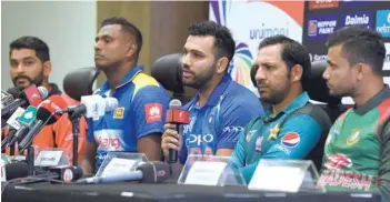  ?? — AFP ?? Indian captain Rohit Sharma (3L) speaks during the Asia Cup press conference as Hong Kong captain Anshuman Rath (L), Sri Lankan captain Angelo Mathews (2L), Pakistan captain Sarfraz Ahmed (3R) and Bangladesh captain Mashrafe Mortaza (right) look on at the Dubai Internatio­nal Cricket Stadium in Dubai on Friday.