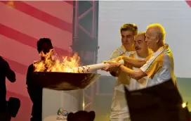  ?? Paulo. — AFP ?? Former Brazilian football players Ademir da Guia (right), Rivellino (centre) and Zetti light the Olympic torch at Anhembi Park in Sao