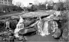  ??  ?? Above left, The distinctiv­e, 32-acre Falls Park on the Reedy in downtown Greenville­opened in 2003. • The porch of the six-room Swamp Rabbit Inn in Greenville is full of rocking chairs. • The Hampton Inn & Suites Greenville Downtown RiverPlace is...