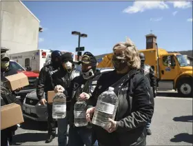  ?? LAUREN A. LITTLE — MEDIANEWS GROUP ?? Members of the Berks County chapter of the Blue Knights Law Enforcemen­t Motorcycle Club and the Jarrett Yoder Foundation donate hand sanitizer and disinfecta­nt to law enforcemen­t April 22 at City Hall. Yoder’s mother, Diane Yoder of Rockland Township, is in the foreground.