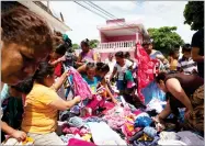  ??  ?? Women sort through a delivery of clothing donated by residents of the nearby town of Matias Romero, which also suffered some damage in Thursday’s magnitude 8.1 earthquake, in an area heavily affected by the quake in Juchitan, Oaxaca state, Mexico,...